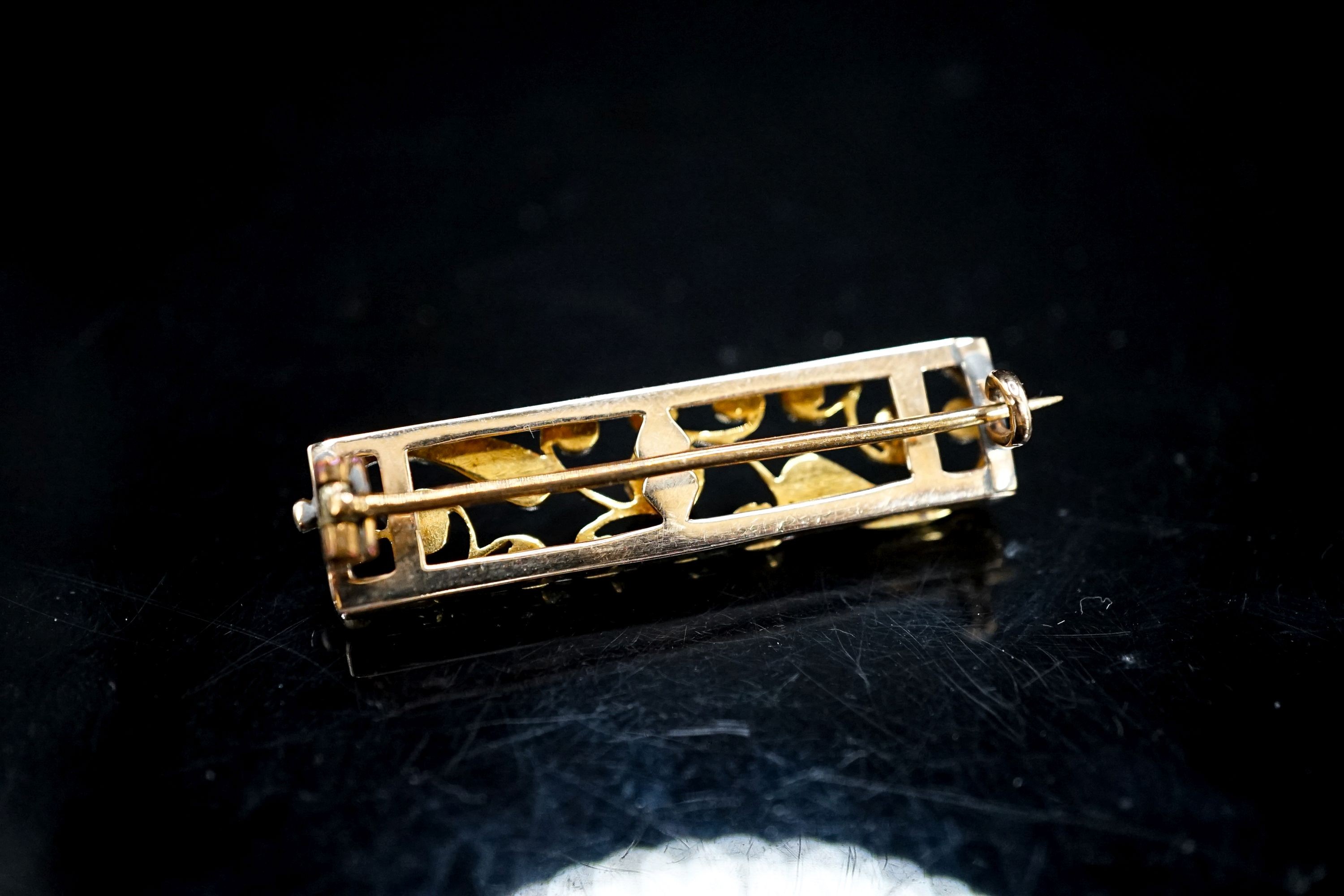 An early 20th century yellow metal and seed pearl set rectangular bar brooch, 38mm